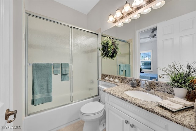 full bathroom with combined bath / shower with glass door, tile patterned floors, vanity, ceiling fan, and toilet