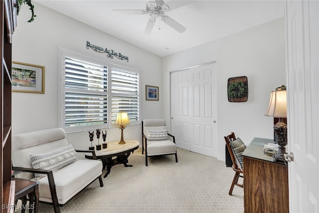 carpeted home office featuring ceiling fan