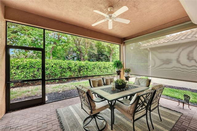 sunroom / solarium featuring ceiling fan