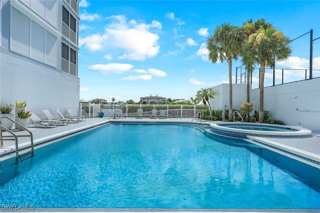 view of swimming pool with a community hot tub