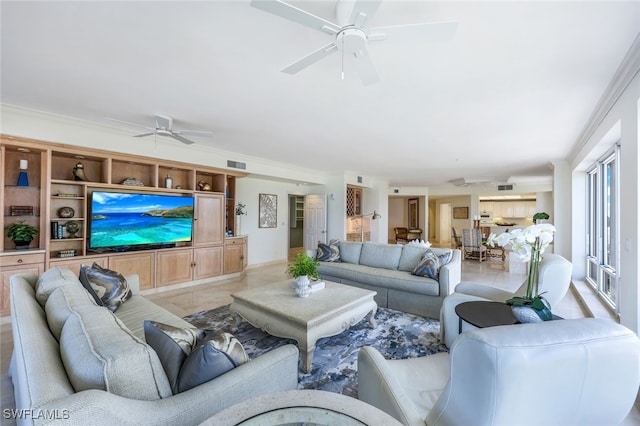 tiled living room with ceiling fan and ornamental molding