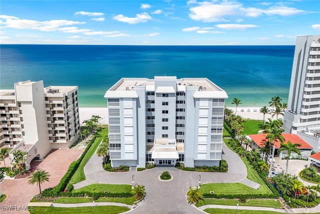 drone / aerial view with a water view and a view of the beach