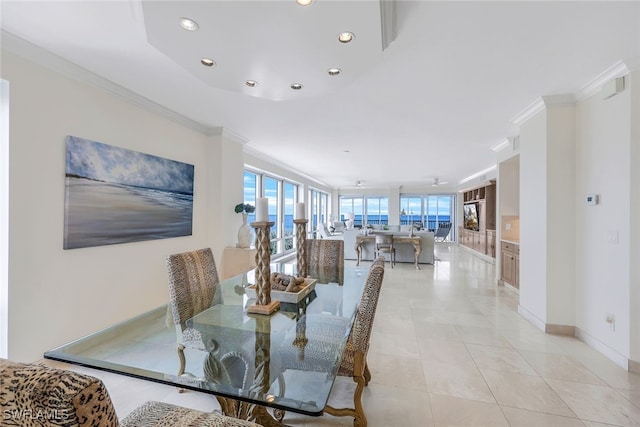 tiled dining room with a wealth of natural light and ornamental molding