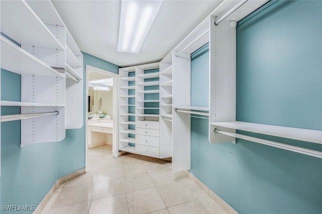 spacious closet featuring light tile patterned floors