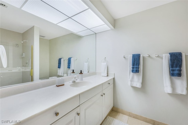 bathroom featuring tile patterned floors, vanity, and a shower with door