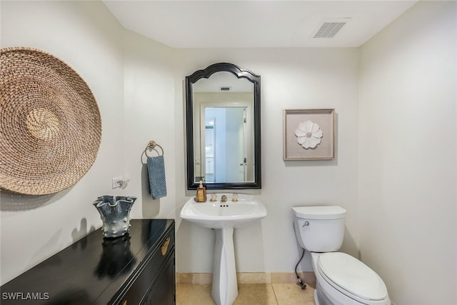 bathroom with tile patterned flooring and toilet