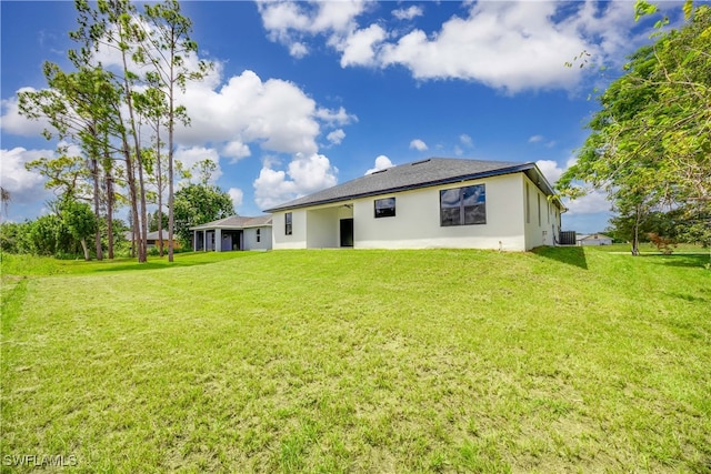 back of property featuring a lawn