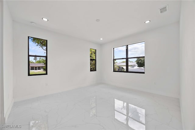 unfurnished room featuring plenty of natural light