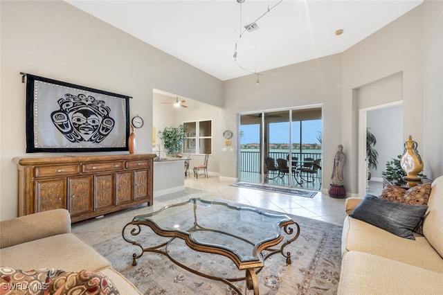 living room with light tile patterned floors and ceiling fan