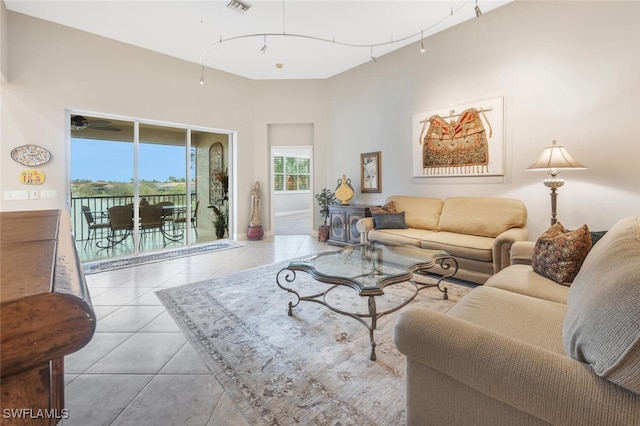 tiled living room with ceiling fan