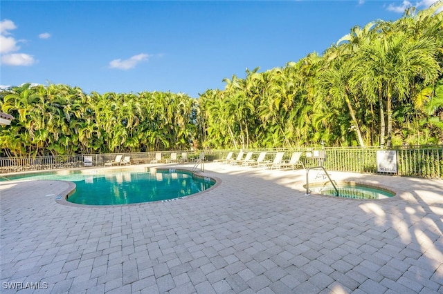 view of pool with a patio area and a community hot tub