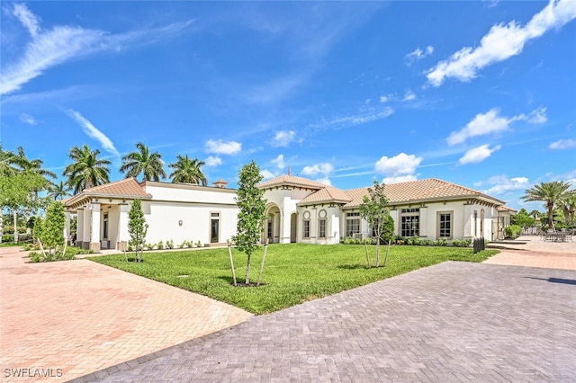 mediterranean / spanish-style home featuring a front yard