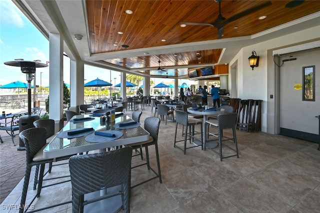 dining room with plenty of natural light, ceiling fan, and wooden ceiling