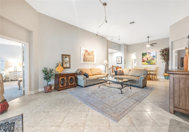 living room featuring light tile patterned floors, track lighting, and ceiling fan