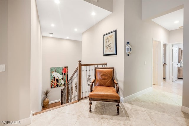 living area featuring radiator heating unit and light tile patterned floors