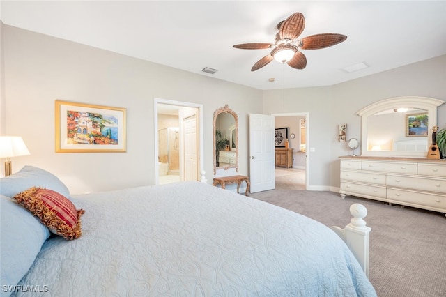 bedroom featuring ceiling fan, ensuite bathroom, and light colored carpet