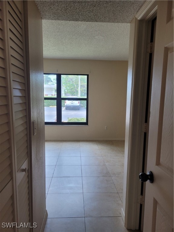 unfurnished room featuring light tile patterned flooring