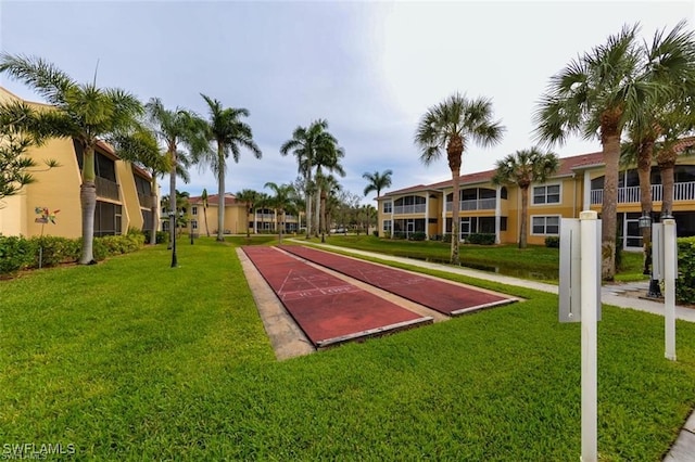 view of property's community with a lawn