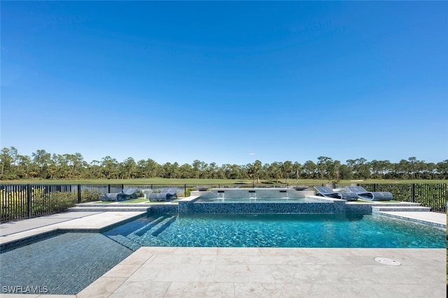 view of swimming pool with an in ground hot tub