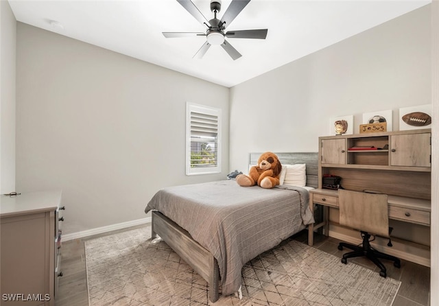 bedroom with light hardwood / wood-style flooring and ceiling fan