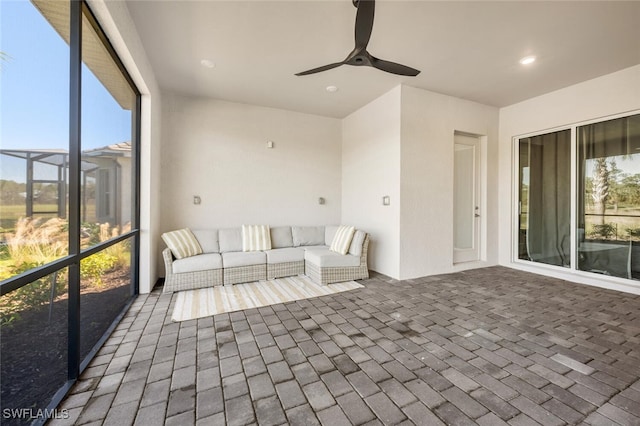 unfurnished sunroom with ceiling fan