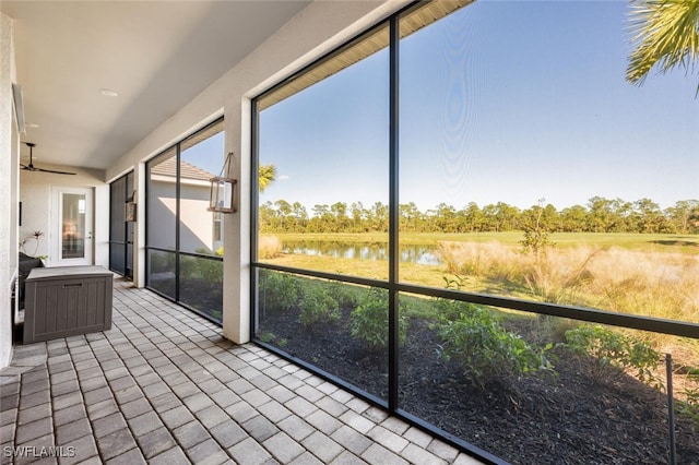 unfurnished sunroom with a water view