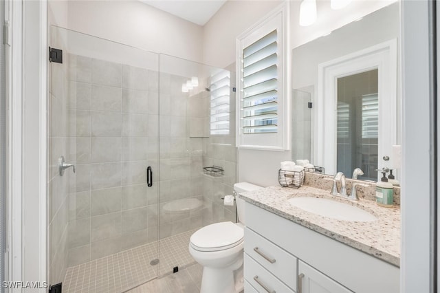 bathroom featuring walk in shower, tile patterned flooring, vanity, and toilet