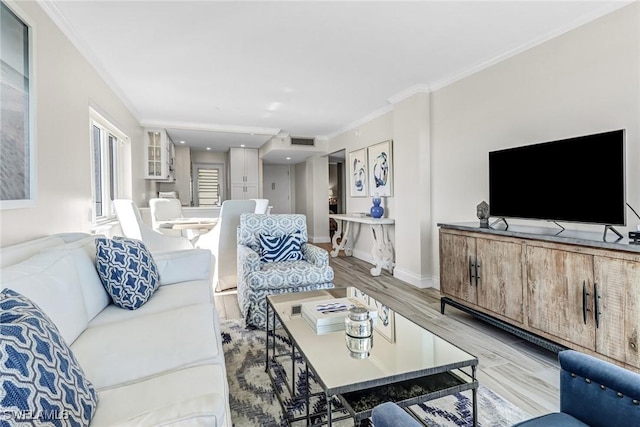 living room with light hardwood / wood-style flooring and ornamental molding