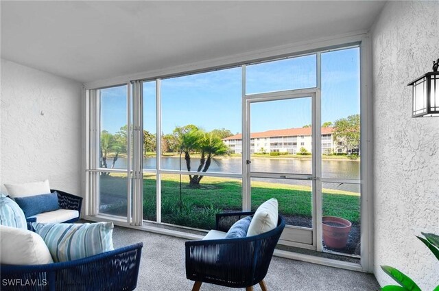 sunroom / solarium with a water view and a wealth of natural light