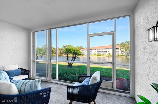 sunroom with a water view and plenty of natural light