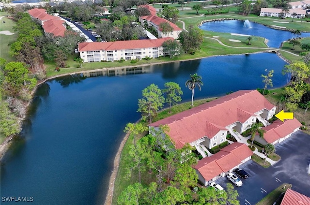 birds eye view of property with a water view