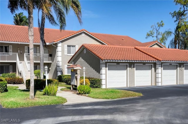 mediterranean / spanish-style home with a garage