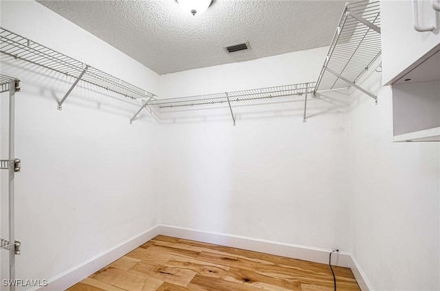 walk in closet featuring hardwood / wood-style floors