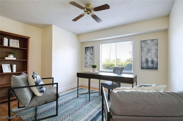 office featuring a textured ceiling, hardwood / wood-style flooring, and ceiling fan