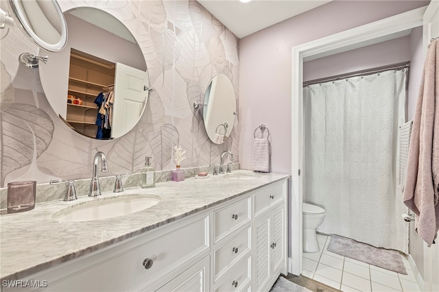 bathroom with tile patterned floors, vanity, and toilet