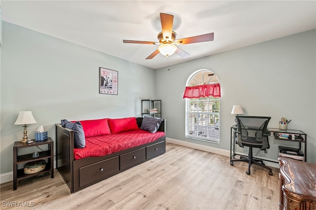 bedroom with ceiling fan and light hardwood / wood-style floors