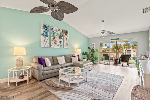 living room with ceiling fan, vaulted ceiling, and light hardwood / wood-style flooring