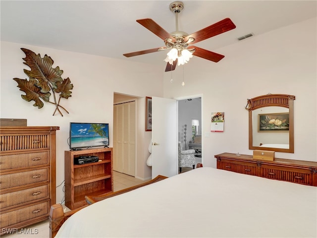 tiled bedroom with ceiling fan and a closet