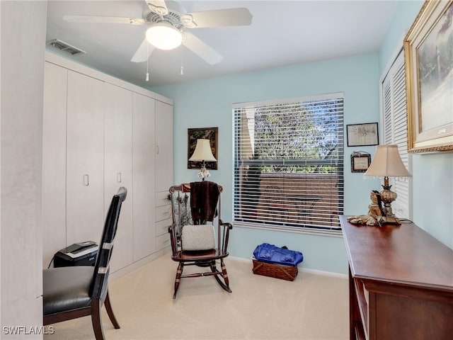 carpeted office with ceiling fan