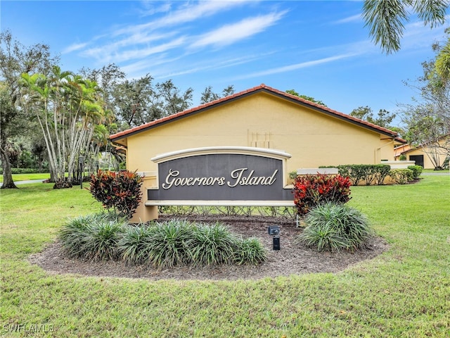 community sign featuring a lawn