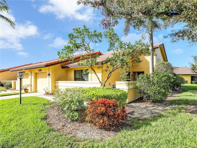 view of front of house with a front yard and a garage