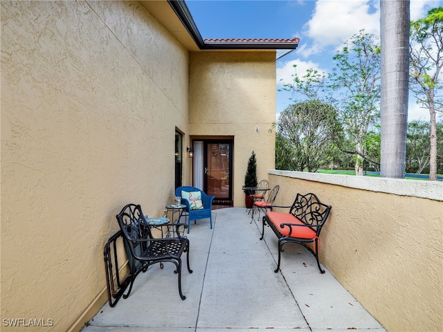 view of patio featuring a balcony