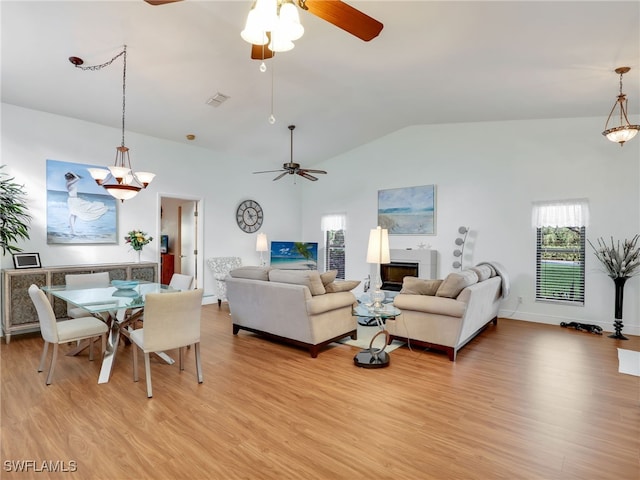 living room featuring light hardwood / wood-style floors, vaulted ceiling, and ceiling fan