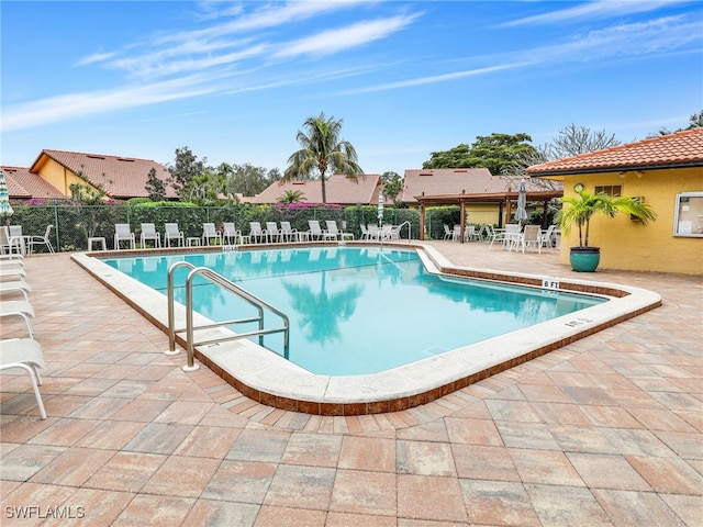 view of swimming pool with a patio