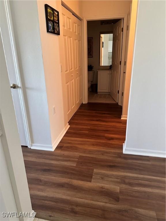 corridor with dark hardwood / wood-style floors