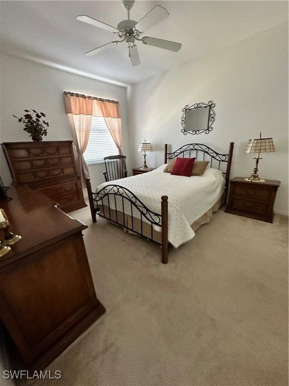 carpeted bedroom featuring ceiling fan