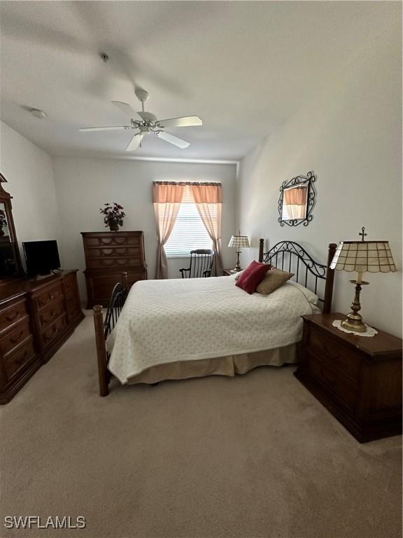 bedroom with ceiling fan and light colored carpet