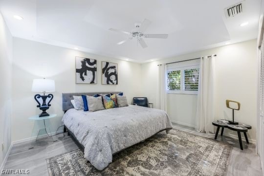 bedroom with wood-type flooring and ceiling fan