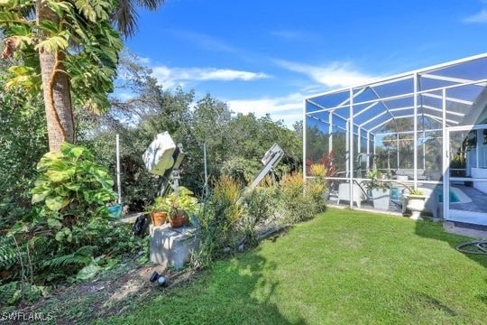 view of yard featuring glass enclosure