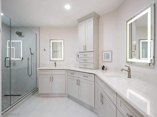 bathroom with a shower with door and vanity